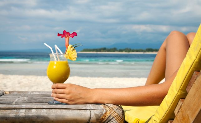 Lady enjoying a tropical drink in the Bahamas | Miami to Bimini Cruise